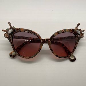 Lele Sadoughi Flower-sided sunglasses.